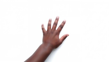 Child's hand making a catching motion on a plain white backdrop
