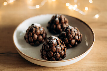Soft natural light photo of handmade chocolate pine cone dessert.