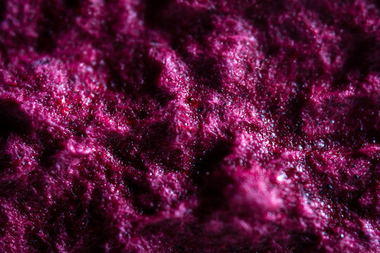 Extreme close up of purple handmade paper clay with a structure and rough texture. Paper recycling. Selective soft focus, shallow depth of field.