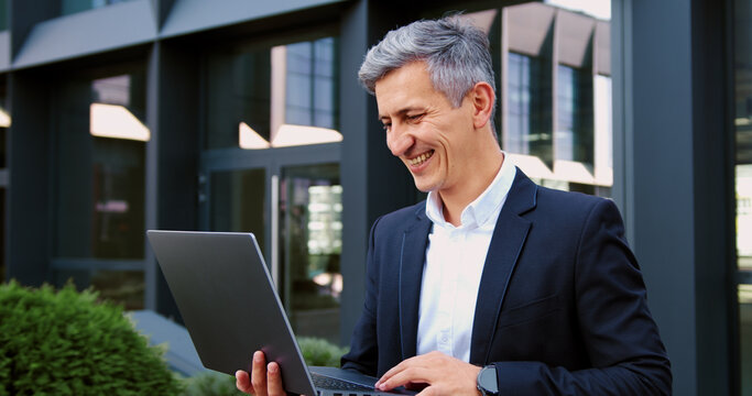 Business man freelancer thinking and reading for remote work, typing and project. Person, computer and journalist in nature for review, feedback and check email