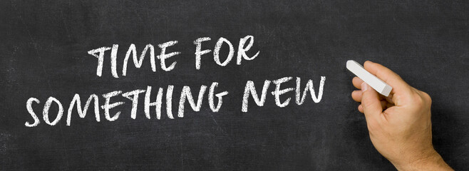 Naklejka premium Text written on a blackboard - Time for something new