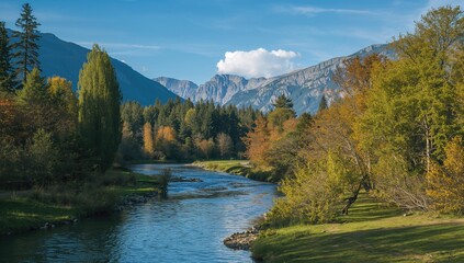 A serene river meanders through lush trees and towering mountains, showcasing seasonal change