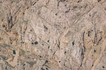 Rocky mountain terrain with sparse vegetation and rugged landscape
