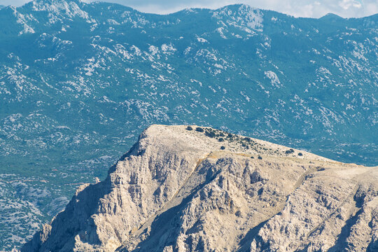 Majestic rocky mountain peak with vast forested landscape in the background