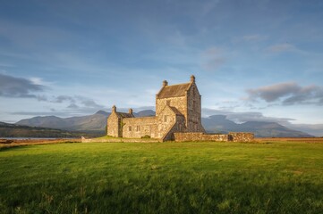 Historic Lord of the Isles' ancient stronghold on a remote island with stone buildings and mountainous landscape