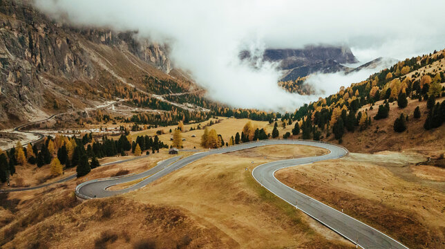 Twisted snake-like asphalt road. Pass near Cortina mountain. Aerial majestic view of popular place at autumn season, background