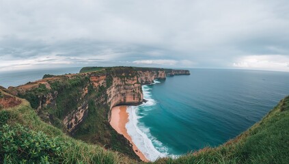 Panoramic view of Uluwatu cliffs in Bali, Indonesia with overcast skies, highlighting erosion risk