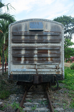 Old weathered train bogy cargo container with rust and scratches, showing aged metal textures and industrial details, perfect for concepts of history, transportation, and decay.