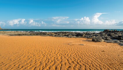 Beautiful sandy shore with abstract patterns and textures of sea, sand, and rocks