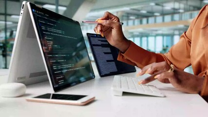 Coding Woman Working On Multiple Monitors - Powered by Adobe