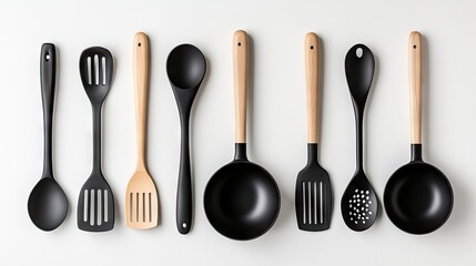Elegant arrangement of black kitchen utensils with wooden handles against a bright white wall showcasing culinary design