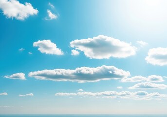 Obraz premium Fluffy white clouds drifting across a bright blue sky