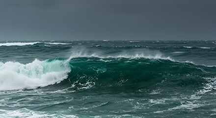 Fototapeta premium Powerful ocean waves crashing under a dramatic, stormy sky, showcasing the raw force of nature.