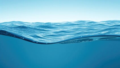 Glossy water surface, side view of waves on a blue backdrop, reflective texture for design use