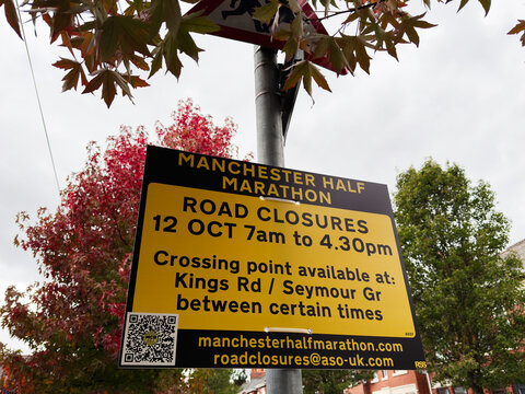 Manchester Half Marathon road closure sign informs runners and residents in Manchester, UK
