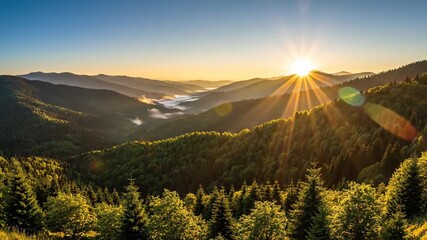 Mountainous landscape unfolds with valley shrouded in fog, set against a warm sunset glow, perfect for nature documentaries, environmental campaigns, or serene atmosphere visuals showcasing the.