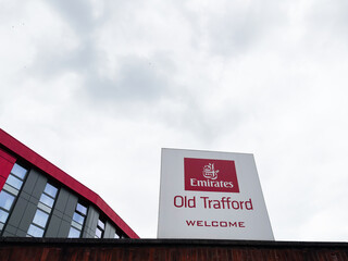 Obraz premium Emirates Old Trafford sign in Manchester welcoming visitors to the stadium