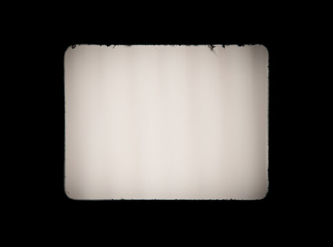 Old, blank projector film frame isolated on black background with copy space
