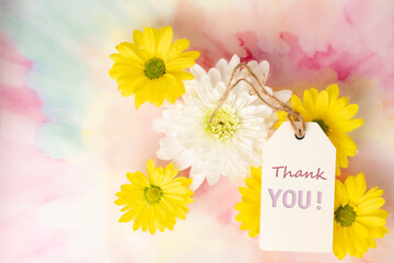 Thank you, message note tag, with beautiful white chrysanthemum and bright yellow daisy flowers above a swirled tie-dyed pink, blue, purple background.