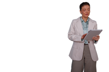 Businesswoman standing, looking at tablet, working on digital technology, researching and analyzing data with empty space, transparent background