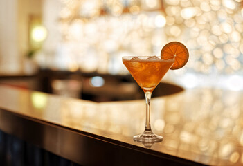 Elegant Orange Cocktail Glass with Ice and Slice of Orange in Golden Light