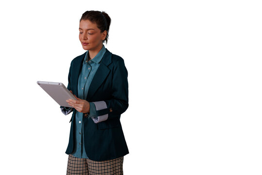 Businesswoman reviewing data on a tablet, a focused professional standing, working and analyzing information