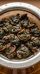 Close-up of Oolong Tea Leaves Steeping in a Metal Infuser.
