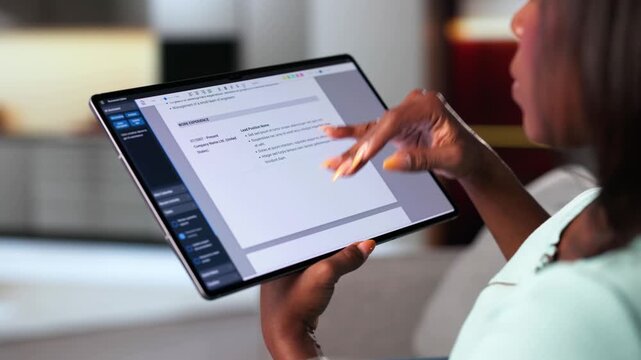 Woman Preparing Resume For Job Interview On Tablet At Home