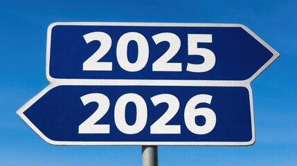 Blue signpost with directional arrows indicating the years 2025 and 2026 against a clear blue sky, symbolizing planning and future direction