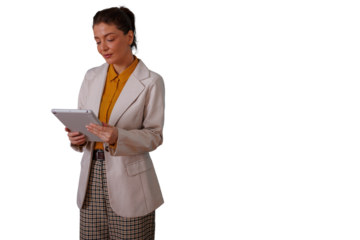 Professional woman standing, holding a device, checking information on a tablet, managing tasks and digital workflow