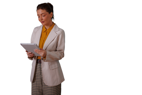 Professional woman standing, holding a device, checking information on a tablet, managing tasks and digital workflow