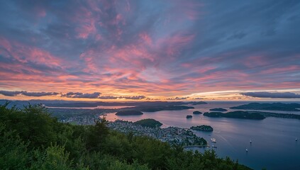 Fototapeta premium Alesund's vibrant sunset sky casting warm hues over Valderoya and nearby islands, seasonal change