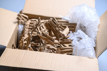 Flat view of riffled corrugated cardboard strips with bubble wrap layer inside opened box for eco-conscious protective packaging materials