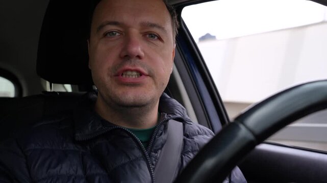 Man's car journey: from earnest discussion and gesturing to quiet contemplation and serene moments with closed eyes.
