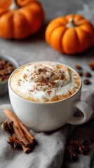 Creamy pumpkin spice latte in a white mug topped with whipped cream and cinnamon, surrounded by decorative pumpkins and coffee beans, creating a cozy autumn atmosphere