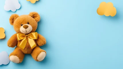 Fotobehang Dierenarts Cute teddy bear with golden bow surrounded by fluffy paper clouds on a pastel sky backdrop creates a whimsical atmosphere  © pvl0707
