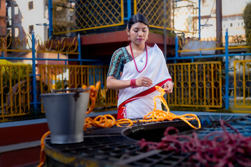 Newari Girl in tradional attire Drawing Water from a Traditional Hiti