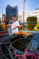 Newari Girl in tradional attire Drawing Water from a Traditional Hiti