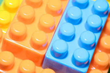 Plastic colored construction blocks, close-up.