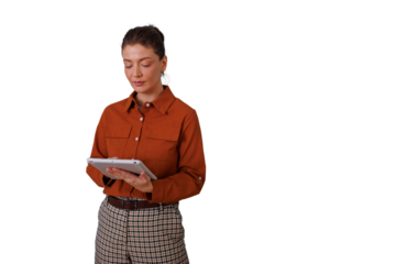 Businesswoman standing, concentrating on digital tablet, managing tasks, using modern technology with transparent background