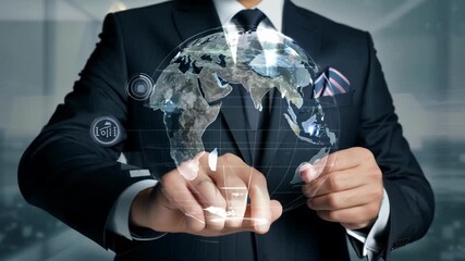 Man in formal suit holds transparent digital hologram of rotating world map symbolizing global business network and futuristic technology concept - Powered by Adobe