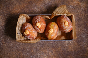 bomboloni with cream filling in a tray 