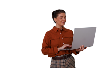 Businesswoman standing and typing on a laptop, engaged in remote work, online learning, or digital communication. Transparent background