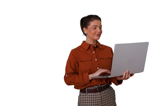 Businesswoman standing and typing on a laptop, engaged in remote work, online learning, or digital communication. Transparent background
