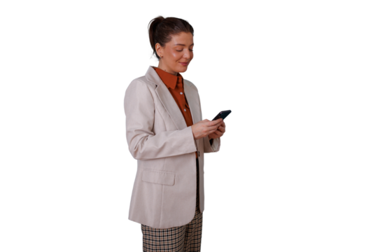 Businesswoman standing, smiling and engrossed in smartphone, checking messages or browsing, transparent background - Powered by Adobe