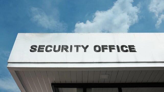 Security Office word sign displayed on a commercial or governmental building under a clear blue sky, symbolizing private protection, surveillance, safety management, control room, monitoring