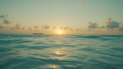 Tranquil sunrise over a calm ocean.