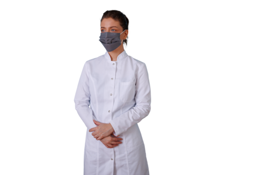 Healthcare worker standing with arms crossed, wearing a protective mask and uniform, offering medical support and safety