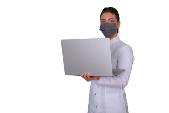 Female doctor wearing mask and lab coat using laptop, delivering telehealth and online medical consultation services
