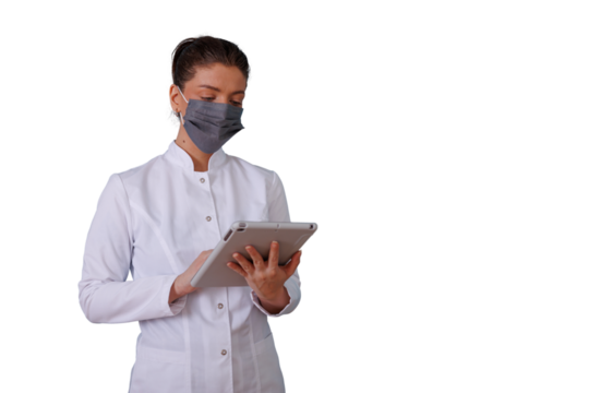 Healthcare professional woman wearing face mask and lab coat using digital tablet, observing medical data, transparent background